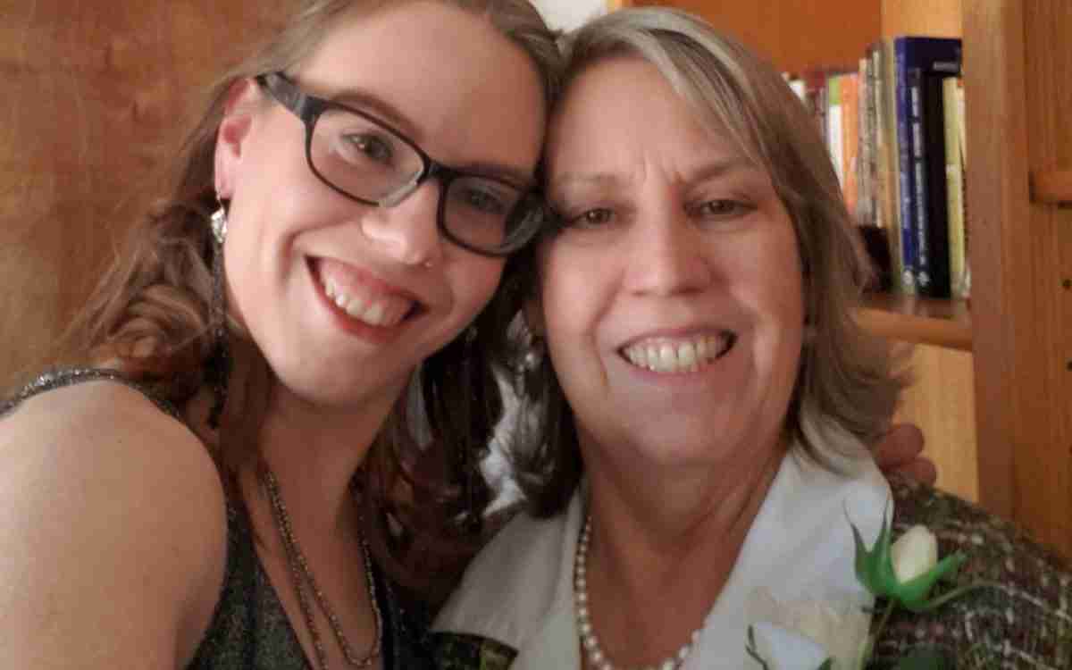 young woman and mother smiling at camera