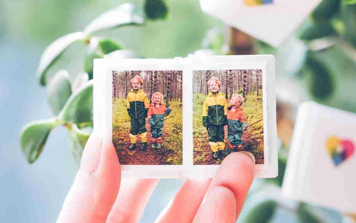 a woman's hand holding a tiny photo book