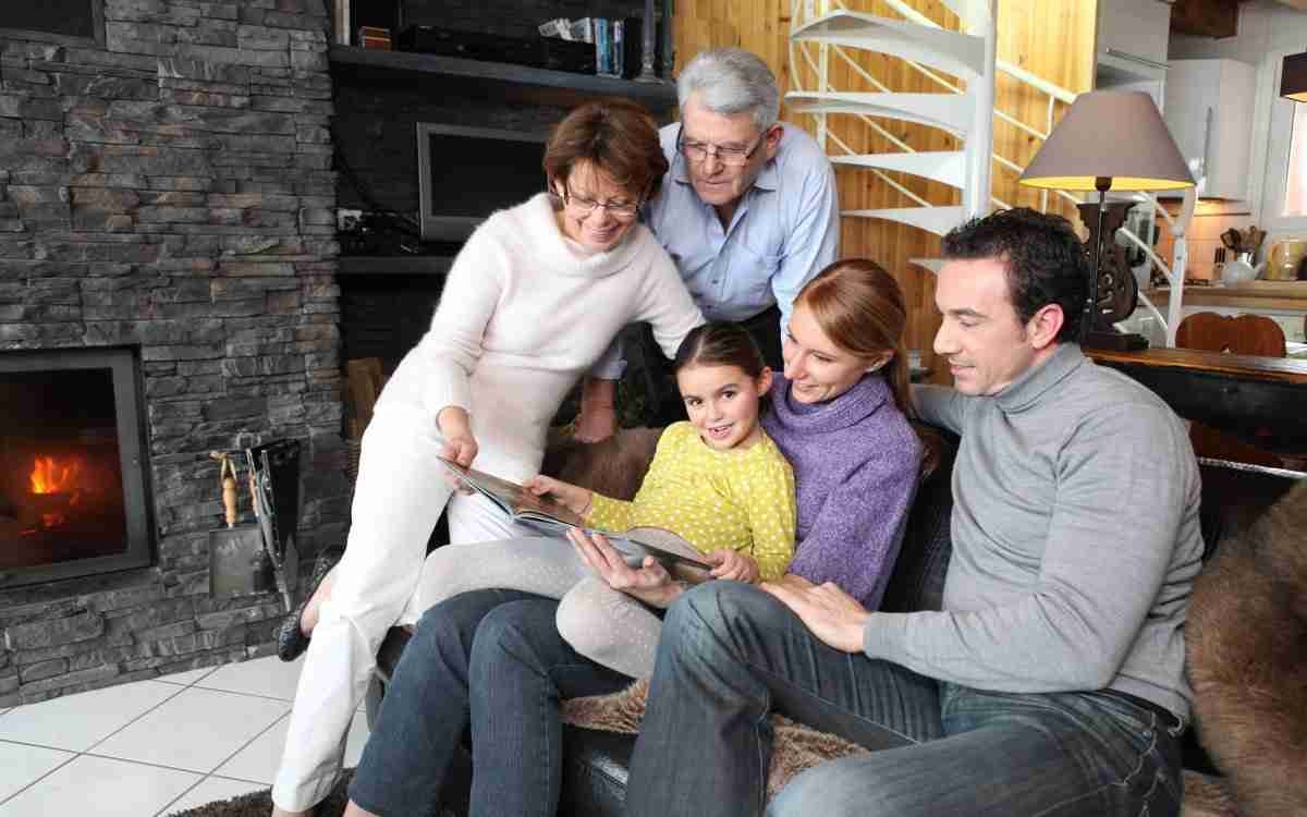 Family gathered together looking at photographs