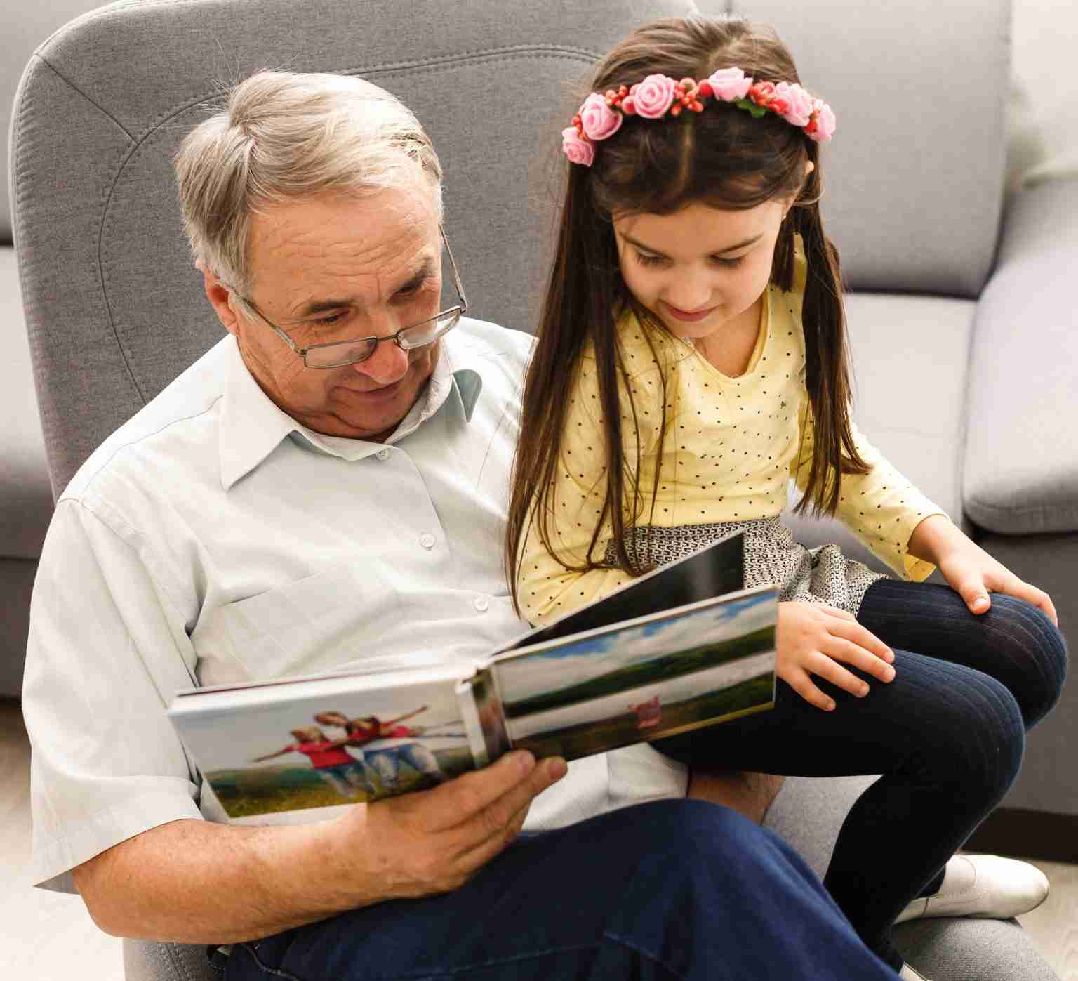 Grandfather and granddaughter looking at a photo book together after using the Planning Power Pack
