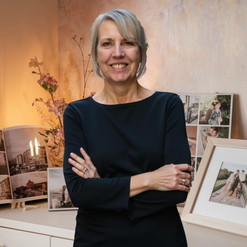 a woman standing in front of a table with pictures